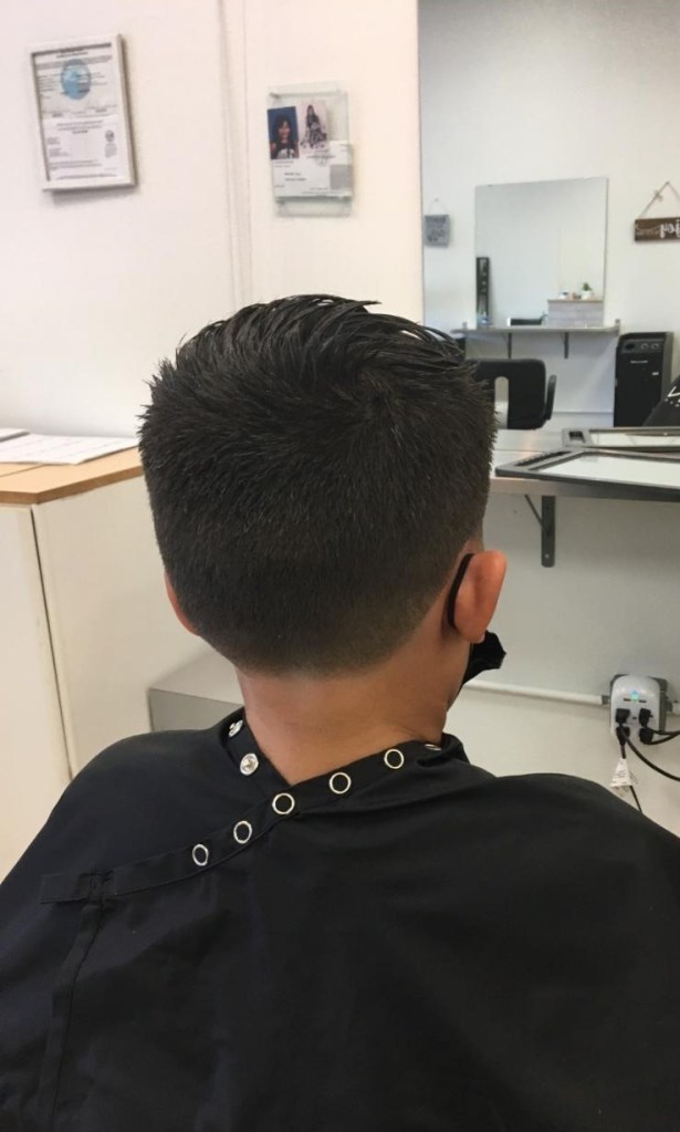 boy with short on back and long on top hairstyle
