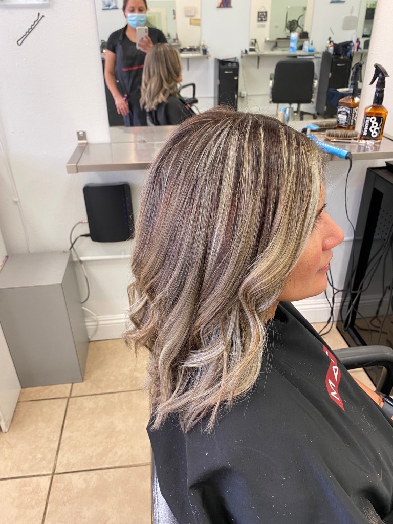 straight dark blonde hair with waves and brown highlights