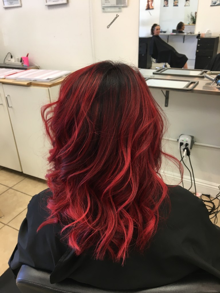 long bright red wavy hair with black highlights