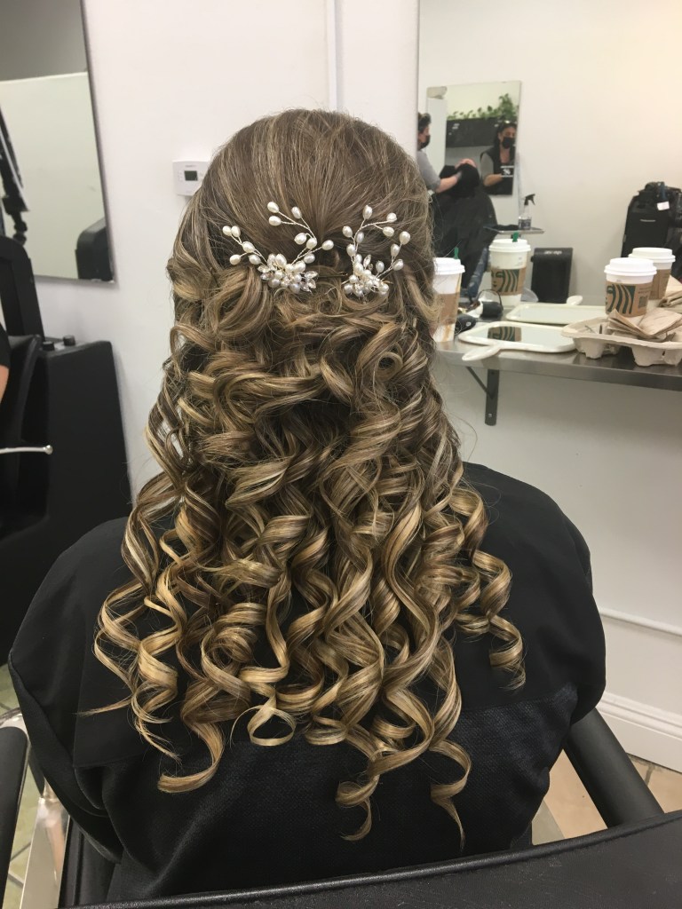 long hair styled with intricate curls and flowers