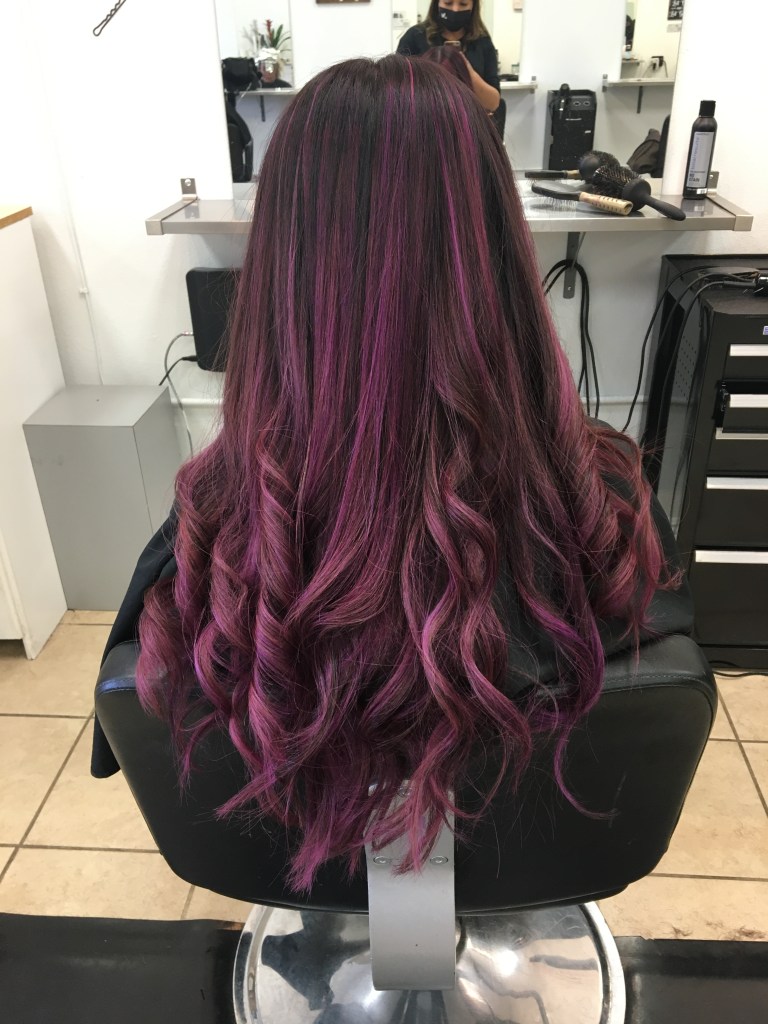 long hair with curls at the bottom and black to purple hombre